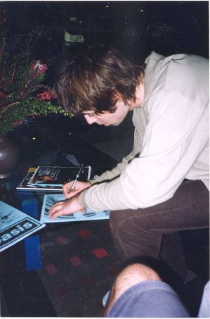 Liam signing a fanzine